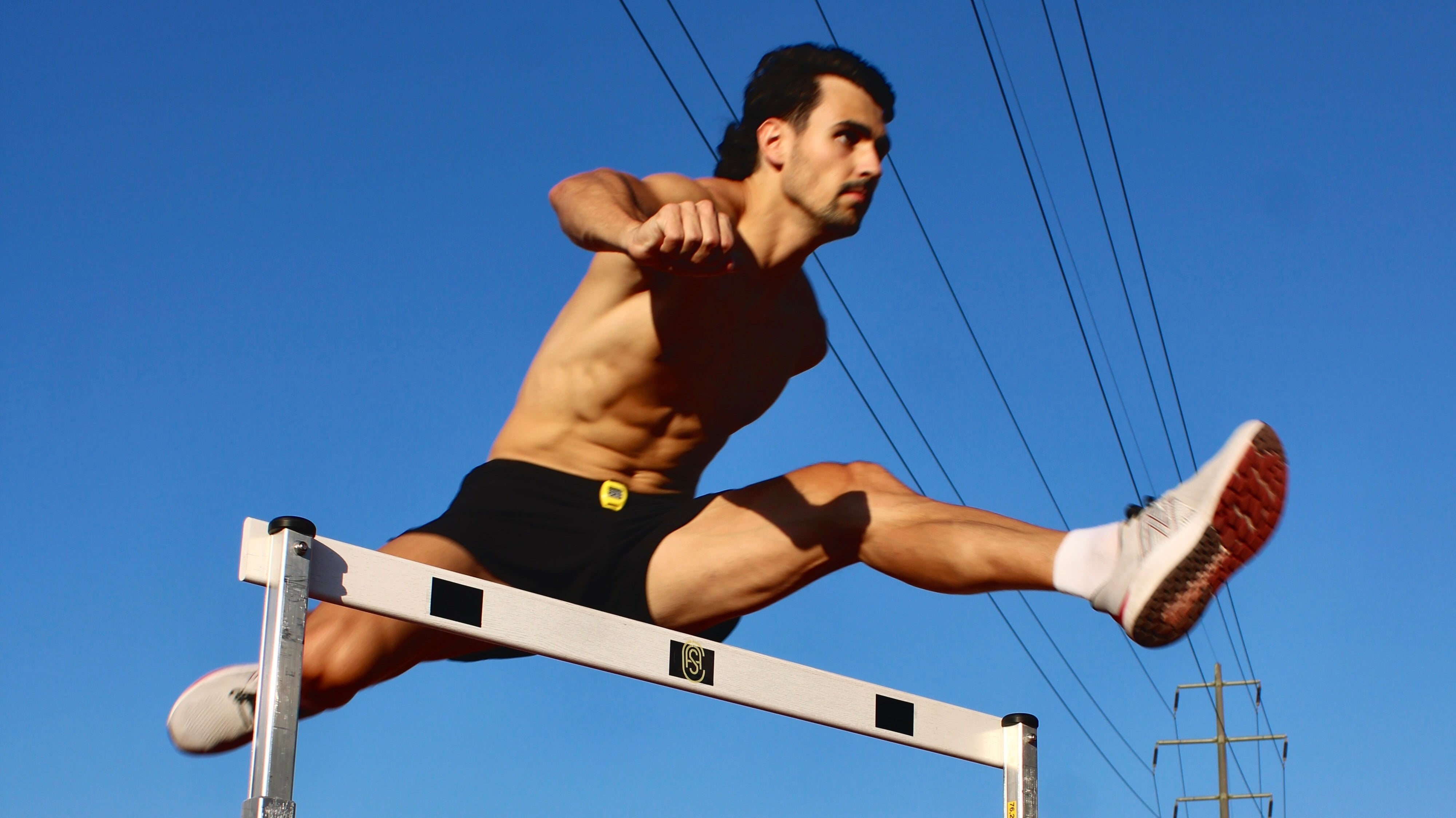 Man jumping over gate during an obstacle course