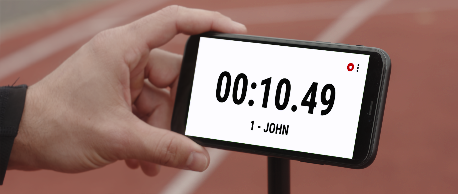 Athlete checking live sprint timing results on smartphone using the MyFreelap app by Freelap Canada Timing System
