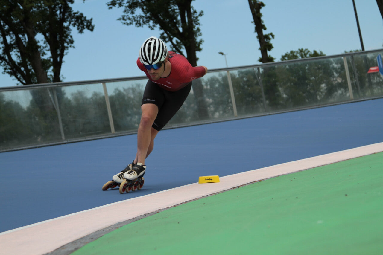 Speed skating summer training with Freelap Canada wireless timing system – athlete sprinting with FxChip BLE and Tx Track Pro on track
