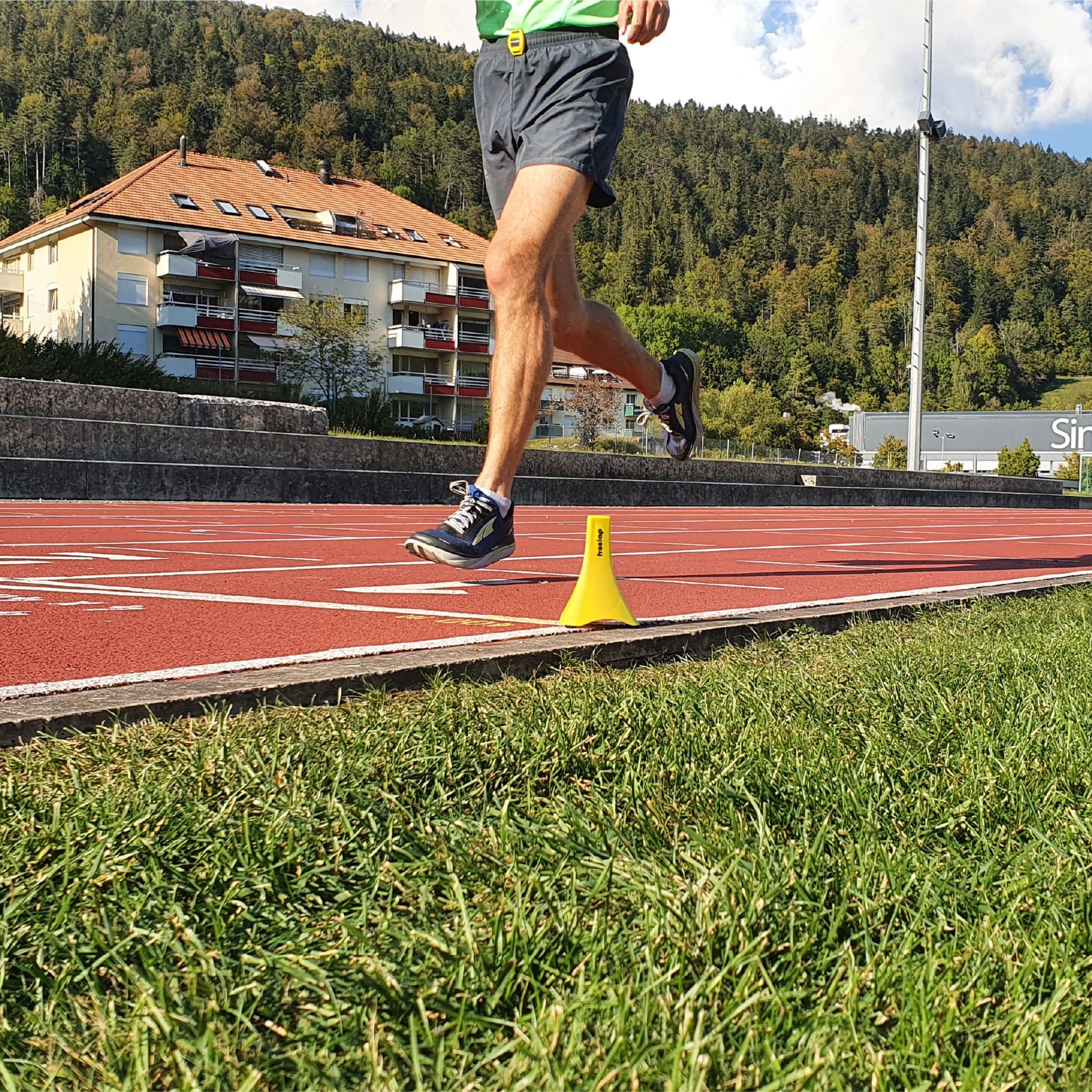 Man doing a flying lap on a track and field